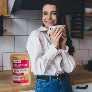 Woman drinking Herbaly's Skinny Leaf Functional Tea showing enjoyment and relaxation